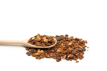 Chocolate granola cereal with nuts in a wooden spoon.