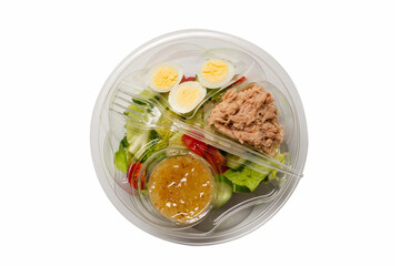 Fresh tuna salad with lettuce, cucombers, cherries and eggs in plastic container.