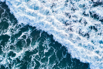 Open sea from aerial top view. Blue water frothy indonesia ocean surface with big wave