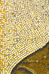 Yellow Texture background of mosaic colored stones on the wall. glossy texture of mosaic tiles on the wall, vertical image.