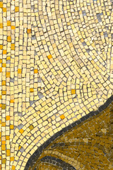 Yellow Texture background of mosaic colored stones on the wall. glossy texture of mosaic tiles on the wall, vertical image.