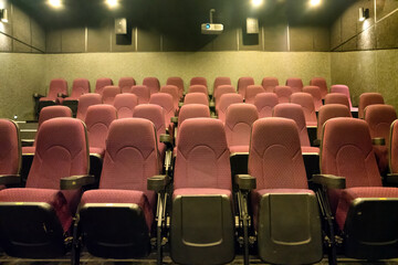Empty seats in movie theater with cinema projector