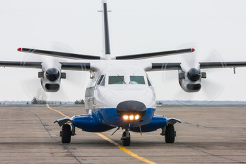 A small regional turboprop airplane at the airport apron