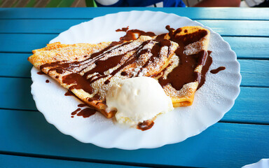 Pancake with vanilla ice cream and chocolate.