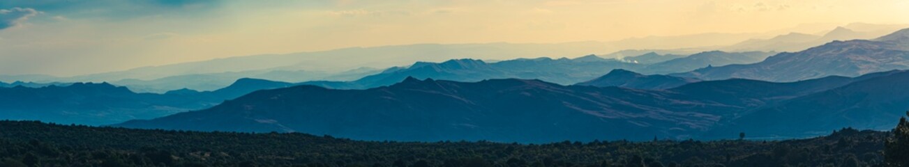 Super wide abstract panorama of hazy mountain hills, natural background, mountain silhouettes