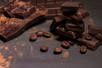 Broken slices of chocolate and coffee beans