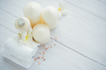 Natural relaxing spa composition on massage table in wellness center    with towels, flowers and...