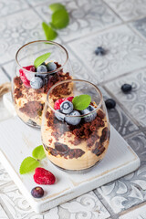 Chocolate dessert in glasses with raspberries and blueberries