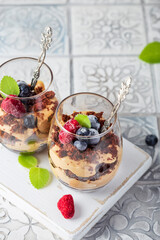 Chocolate dessert in glasses with raspberries and blueberries