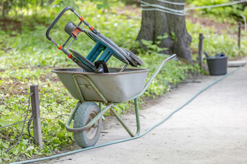 Iron wheel barrow for moving of building materials in the garden and in the backyard