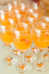 At the banquet, close-up of orange cocktails arranged closely on the table