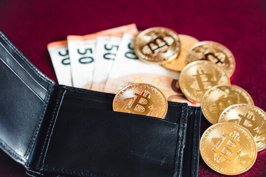 Bitcoins, wallet and money on a table