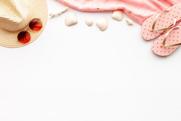 Beach accessories isolated on white. Hat with sunglasses and flip flops. Overhead view