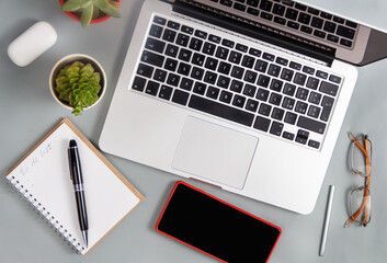 Laptop and modern gadgets on a grey office desk top view