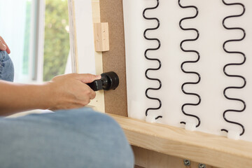 Man assembling sofa furniture at home