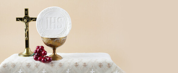 Fototapeta na wymiar The Feast of Corpus Christi Concept. Holy communion and cup of glass with red wine on table.