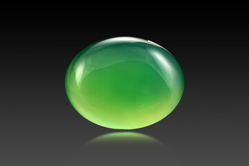 Green agate, onyx, chalcedony oval cabochon. Microcrystalline quartz bright yellowish-green stone. Natural semitransparent gem on black gradient background. Reflection, blur.