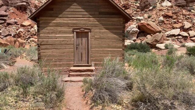 Panning shot of an old schoolhouse in Fruita, Utah in Capitol Reef National Park