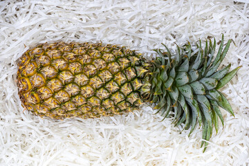 Pineapples on scraps of protective paper.