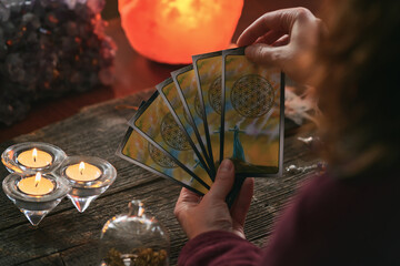 Woman holds tarot cards in her hands
