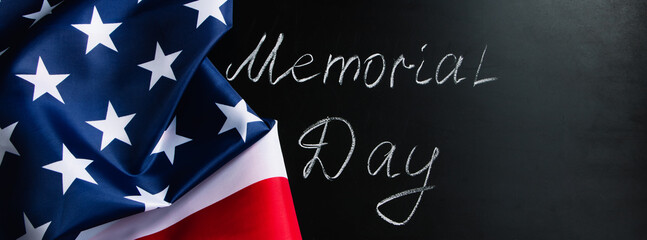 Memorial day concept. Handwritten lettering on black chalkboard and American flag.