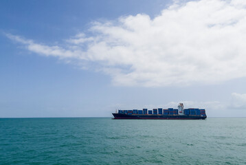 Container ship or container ship loaded with containers freight on the Indian ocean waves near the...