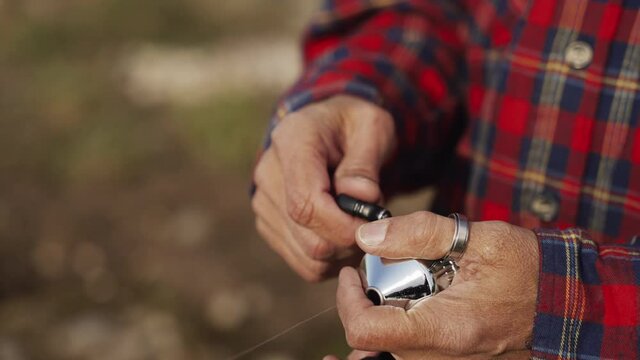 Hands of old man reeling reel fishing rod throw fisher fisherman rod hook salmon fiber glass bait trolling relaxing sea side waves summer day off meditation angler fishing boat nature crabs pond lure