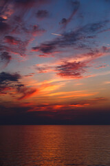 Fototapeta premium A stunning pink and orange sunset sky in the middle of Mediterranean sea, sunset background.
