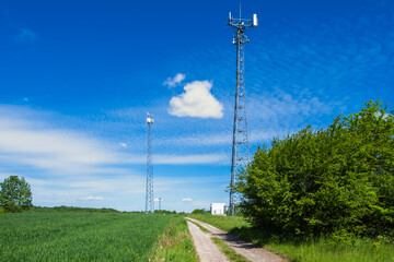 Fototapeta na wymiar Road over hill with telecommunication tower
