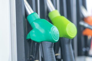 Fuel pump nozzles for different kinds of fuel in a filling station