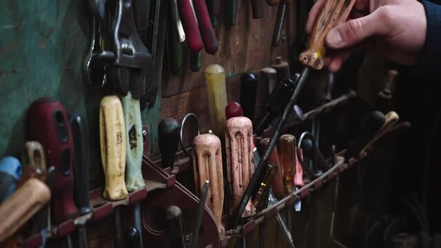 Man with screwdriver at workshop
