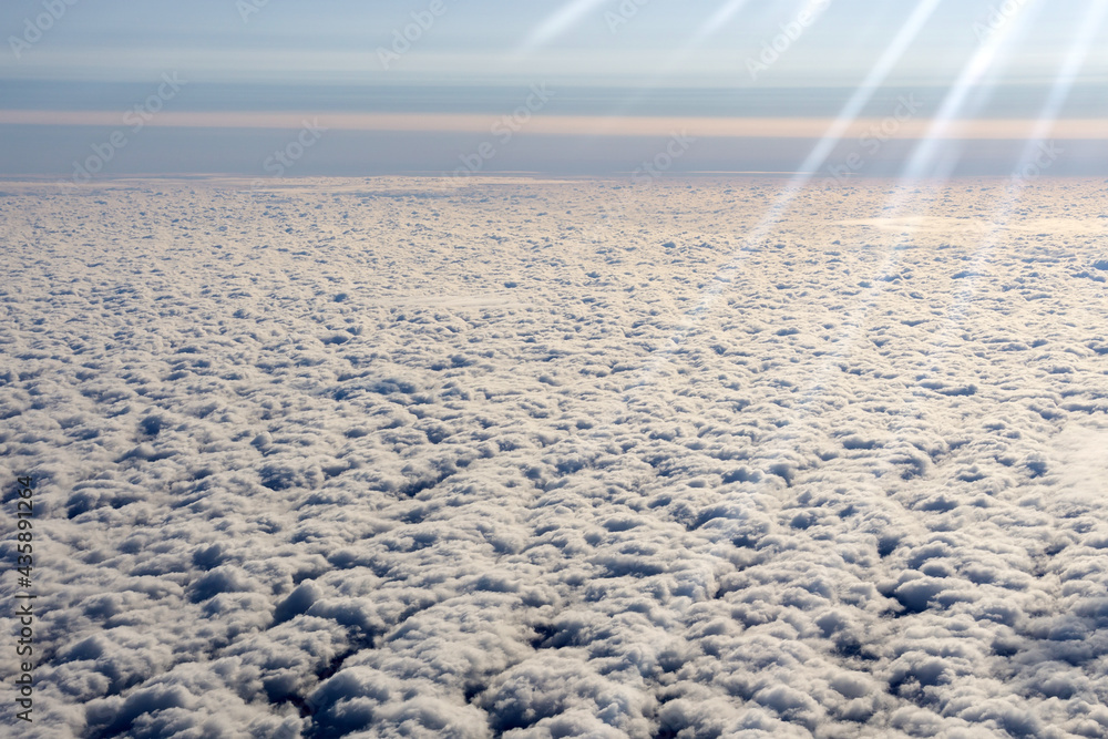 Wall mural clouds sky background with white volumetric foamy clouds in the blue sky. view from the plane. backg