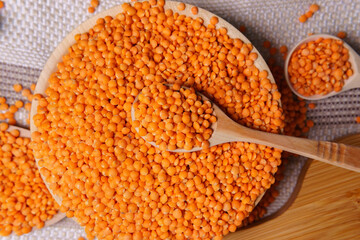 Orange lentils in a wooden bowl. selective focus. Rustic style