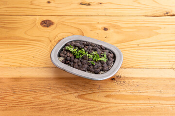 Caribbean rice with black beans served in small stainless steel bowl