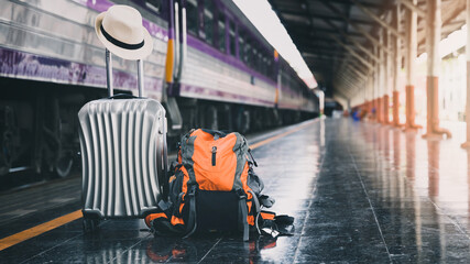Backpack, luggage and hat at train station. Travel concept.