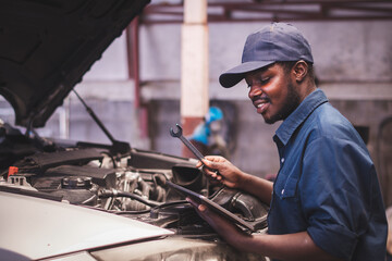 African maintenance male checking car, service via insurance system at automobile repair and check...