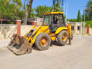 Obraz na płótnie Canvas Mini bulldozer or excavation or loader on road.