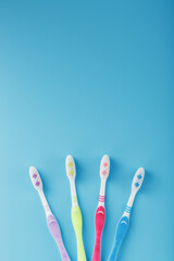 Four toothbrushes on a blue background for the whole family.