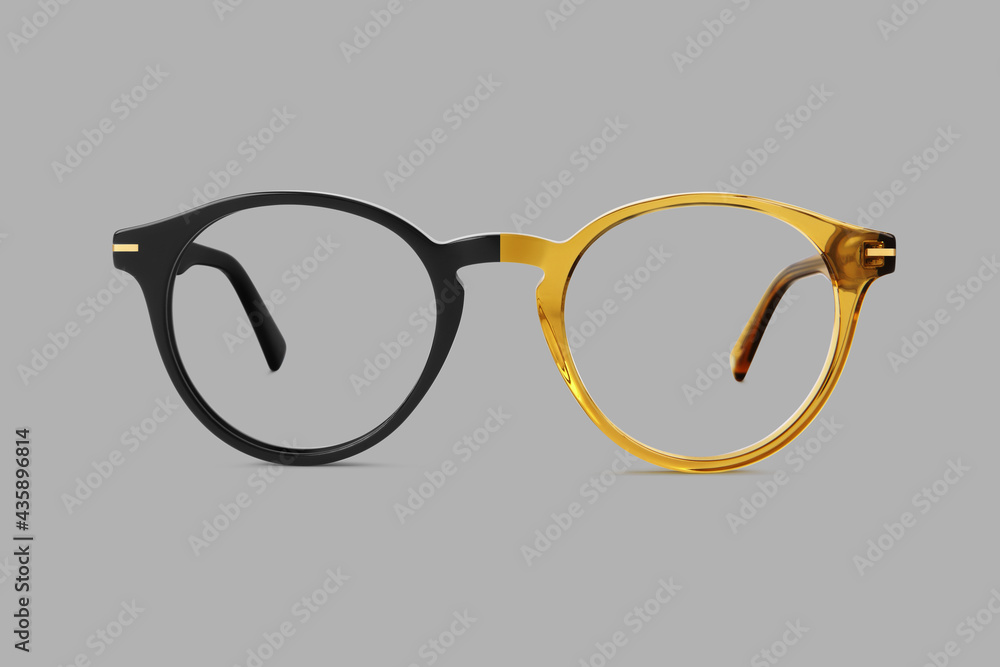 Wall mural beige and black plastic color eye glasses isolated on gray background, ideal photo template for disp