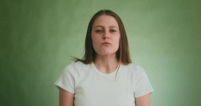 Offended blonde lady tries not to cry looking into camera