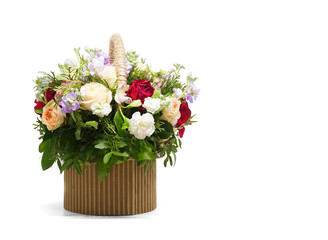 A bouquet of beautiful, bright flowers in a flower basket. Isolated on white background. Side location. Place for text (congratulations, wishes).