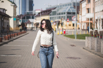 Fototapeta premium A beautiful young brunette hipster girl on the street of her city