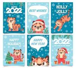 Fototapeta premium New year 2022 cards. Merry christmas poster with cartoon tiger decorate tree. Baby tigers in santa hat. Happy holidays greeting vector set
