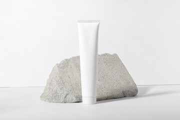 White cosmetic tube on a white background. A nourishing and moisturizing face cream, hand cream or...