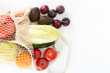 fruits and vegetables in a reusable eco-friendly bag were scattered on the table