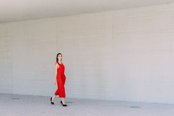 Business woman with red dress walking.