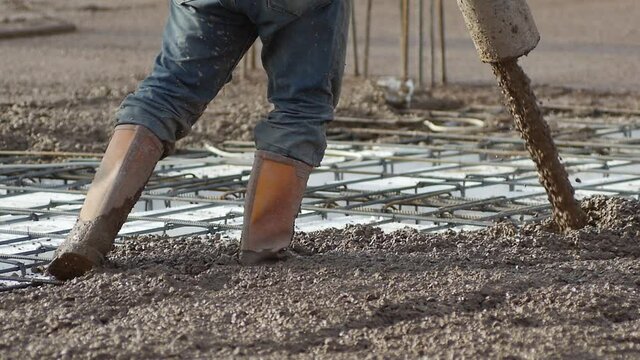 Pouring concrete mix on concreting formwork. Close up, Slow Motion. Forming, an essential part of the entire building process. Before concrete can be poured, forms need to be built to hold the concret