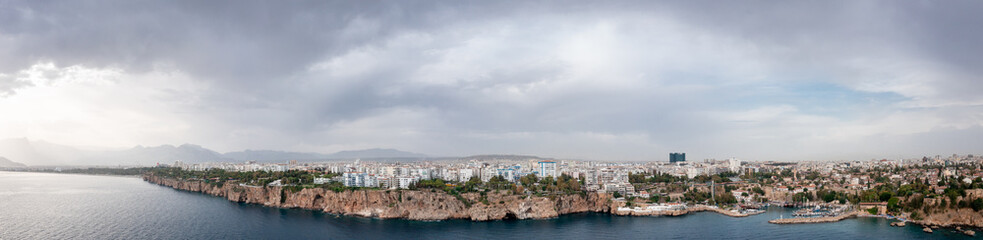 Fototapeta premium Panoramic photo of Antalya, Turkey. View from the sea to the Mediterranean coast and cityscape