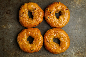 Cinnamon raisin bagels on a dark surface