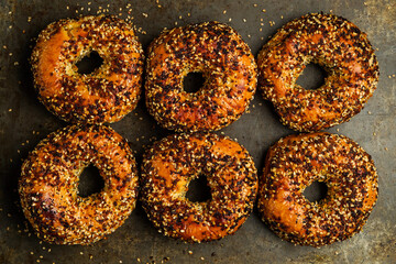 Everything bagels on a dark surface